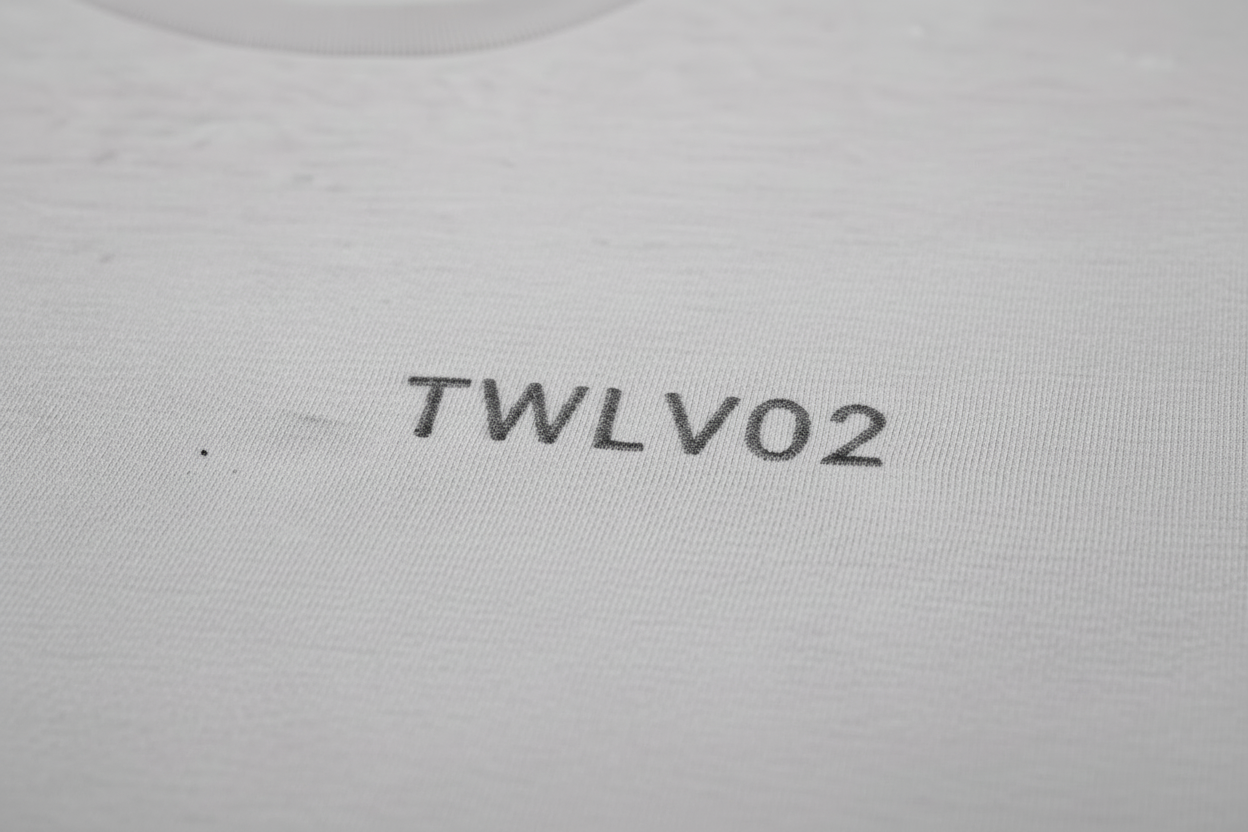 Close-up of embroidered TWLV02 logo on organic cotton t-shirt